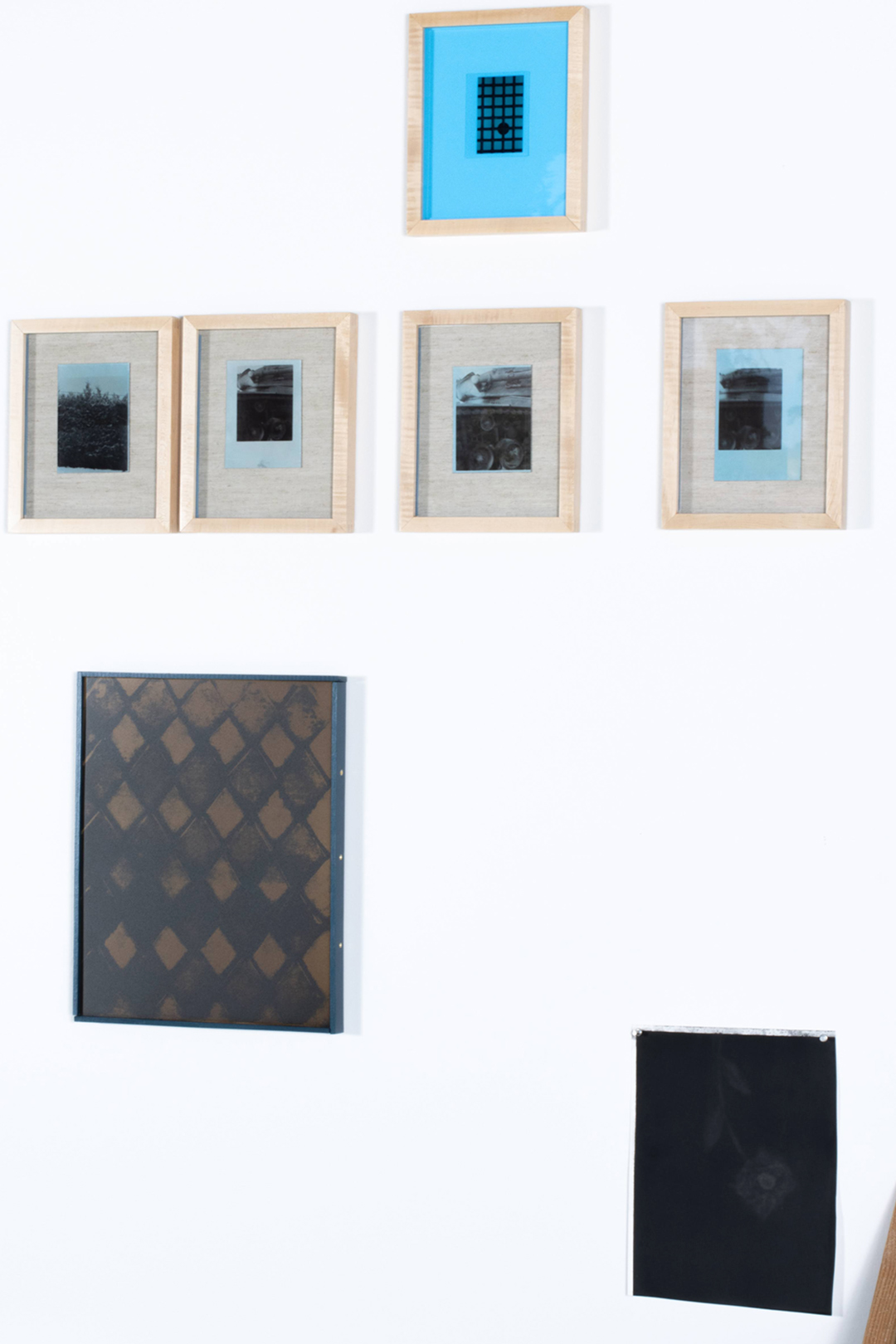 Various framed artworks including small photographic prints.