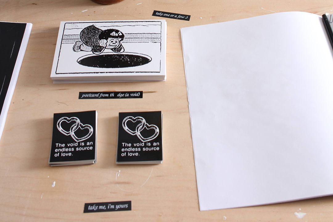 stickers featuring the same image as the above ad, a postcard with a cartoon of Nancy staring into a black hole