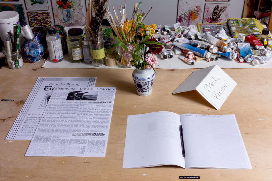 A poster and essay on a table with a vase of flowers
